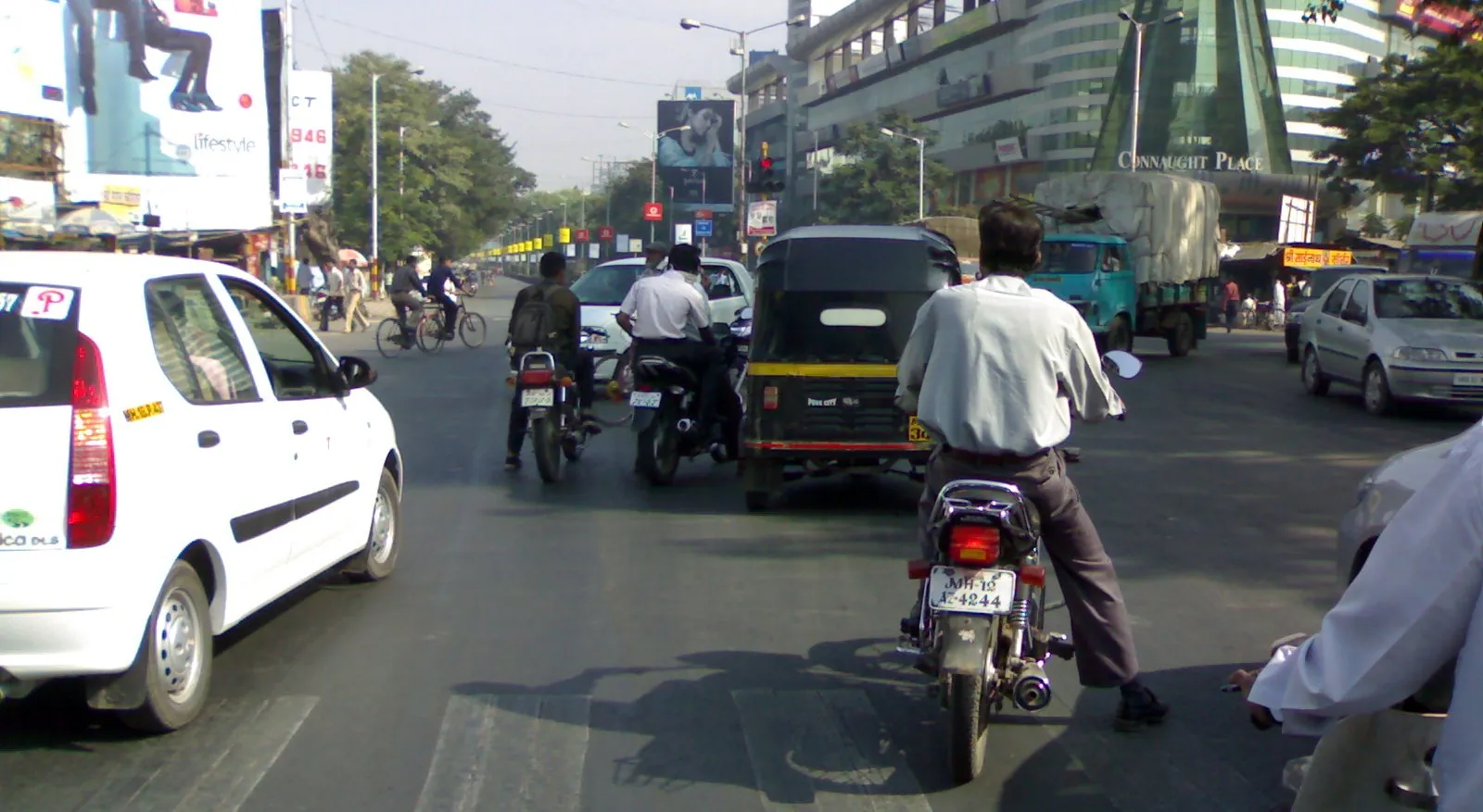 Cars, autos and bikes at a signal on Nagar Road, Pune